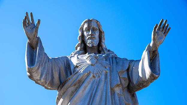 Statue of Jesus with arms out stretched and Sacred Heart Beautiful devotional image of Jesis with his arms outstretched.