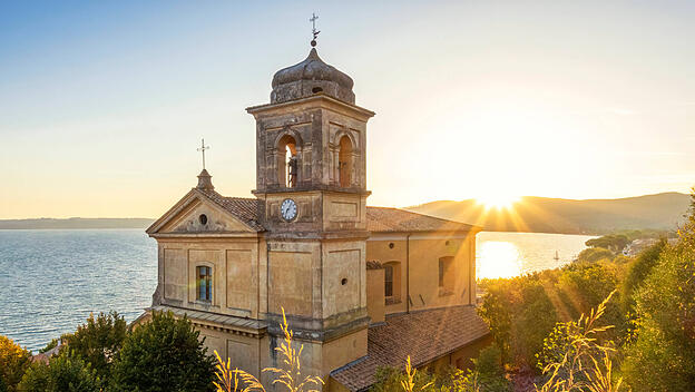 Church Assumption of Virgin Mary near Lake Bracciano at sunset in Italy