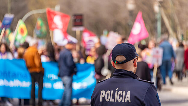 Lisbon, Portugal - 8 March 2020: Back view of a policeman during a protest.